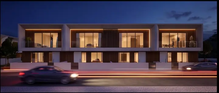 Fachada principal das moradias iluminada à noite